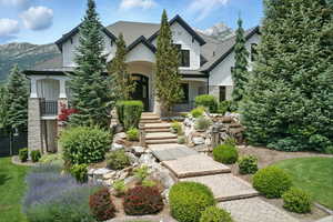 View of front of home with stone siding, a standing seam roof, and a metal roof