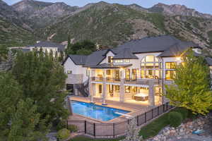 Rear view of property with stairs, a fenced backyard, stucco siding, a patio, and a mountain view