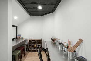 Office featuring an ornate ceiling and light wood-style floors