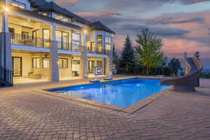 View of swimming pool featuring a water slide and a patio area