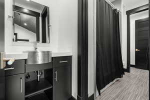 Bathroom with vanity and a shower with shower curtain