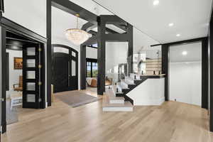 Entryway with wood finished floors, a chandelier, and recessed lighting