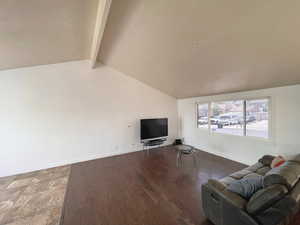Living area with baseboards and wood finished floors