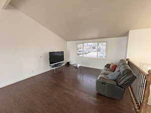 Living room featuring lofted ceiling and wood finished floors
