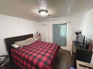 Second Upstairs Bedroom with a textured ceiling and dark carpet