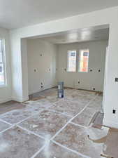 Empty room featuring a textured ceiling and baseboards