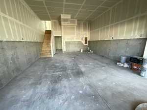 Miscellaneous room with stairs and concrete flooring