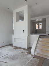 Unfurnished room featuring baseboards and stairs