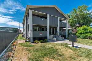 Contemporary house featuring a balcony and board and batten siding