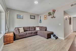 Living area featuring wood finished floors and baseboards
