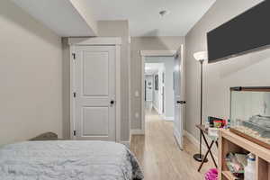 Bedroom with light wood-style flooring and baseboards