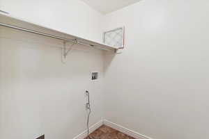 Laundry room with hookup for a washing machine and baseboards