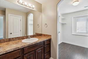 Bathroom featuring vanity and wood finished floors