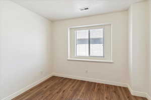 Spare room featuring wood finished floors