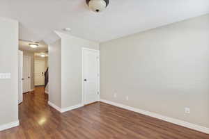 Empty room featuring wood finished floors and baseboards