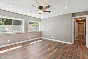 Unfurnished room with dark wood-type flooring, ceiling fan, recessed lighting, and a textured ceiling