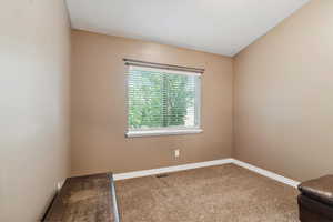 Unfurnished room featuring carpet flooring and baseboards