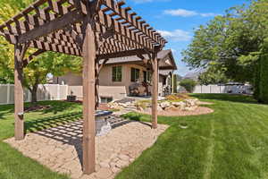 Fenced backyard featuring a patio area and a pergola