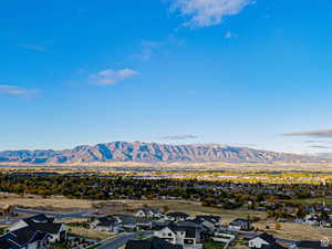 View of mountain backdrop featuring nearby suburban area