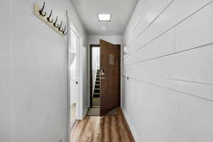 Entryway with wood finished floors and baseboards