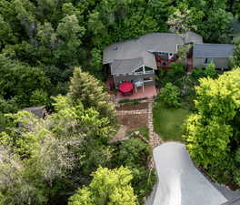 Aerial view of property and surrounding area featuring a heavily wooded area