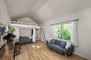 Living area with hardwood / wood-style floors, lofted ceiling, and wooden ceiling