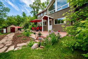 View of yard with a patio and a storage unit