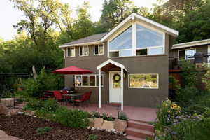 View of front of property featuring stucco siding and a patio