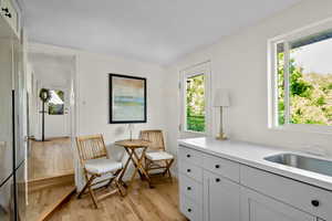 Living area featuring light wood finished floors and baseboards