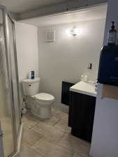 Bathroom with a shower stall and vanity