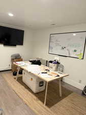 Office featuring wood finished floors and recessed lighting