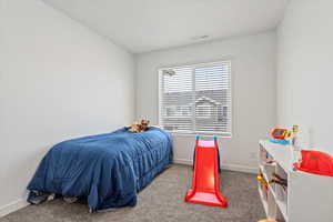 Bedroom featuring carpet flooring and baseboards