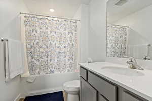 Bathroom featuring vanity and shower / tub combo