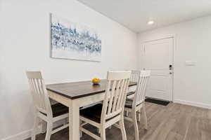 Dining space featuring light wood finished floors and recessed lighting