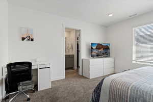 Bedroom with carpet floors, a desk, and recessed lighting