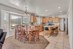 Dining space with recessed lighting and light tile patterned floors