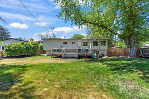 Back of property featuring a wooden deck