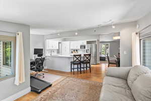 Living area featuring light wood-style flooring and a desk