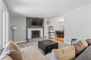 Living area with carpet floors and a fireplace