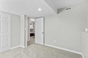Unfurnished bedroom with carpet flooring and baseboards