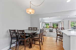 Dining space with light wood finished floors and baseboards
