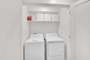 Washroom featuring washing machine and dryer