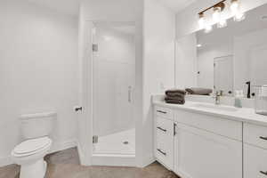Bathroom featuring vanity and a stall shower