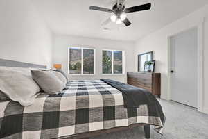 Bedroom with light carpet and a ceiling fan