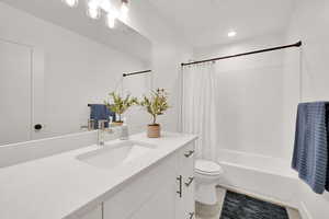 Full bathroom featuring vanity, shower / bath combo, and tile patterned flooring