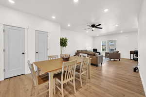 Dining space with light wood-style flooring, recessed lighting, and ceiling fan