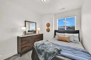 Bedroom featuring carpet and baseboards