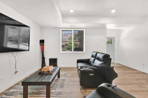 Living room featuring light wood-style flooring and recessed lighting