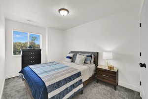 Bedroom with carpet flooring and a textured ceiling
