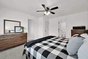 Bedroom with carpet flooring, ceiling fan, and ensuite bath